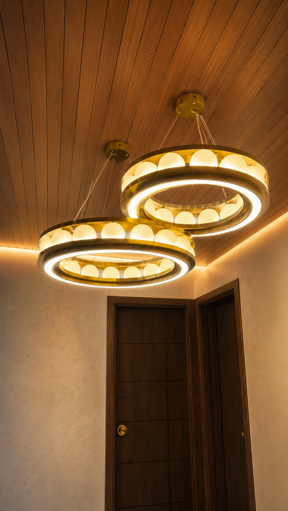 Close detail of crystal chandelier arms catching warm light